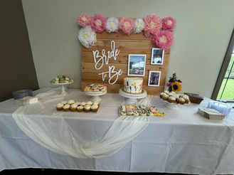 Dessert table with "Bride To Be" sign, cake, cupcakes, cookies.