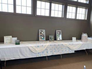Decorated table with photo frames, cards, and banner. Photo Gallery.